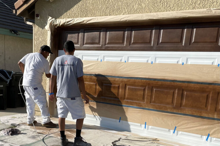 professionals applying Platinum PRO to a garage door